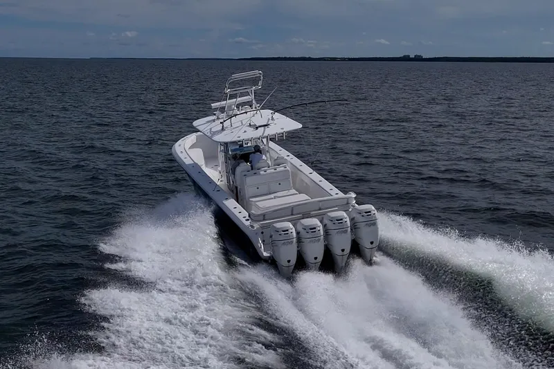 Slide: The Image of 2015 Bahama 41 boat cruising on open water with powerful outboard engines. - 37