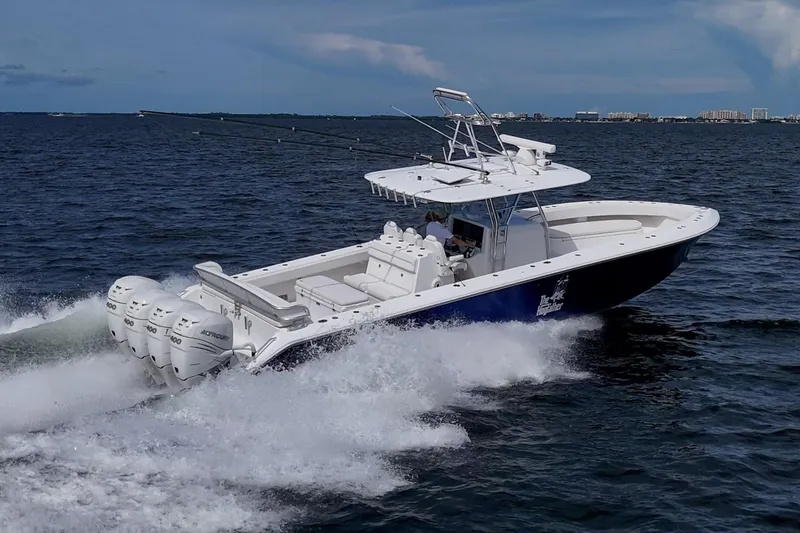 Slide: The Image of 2015 Bahama 41 boat cruising on open water with four powerful engines. - 38