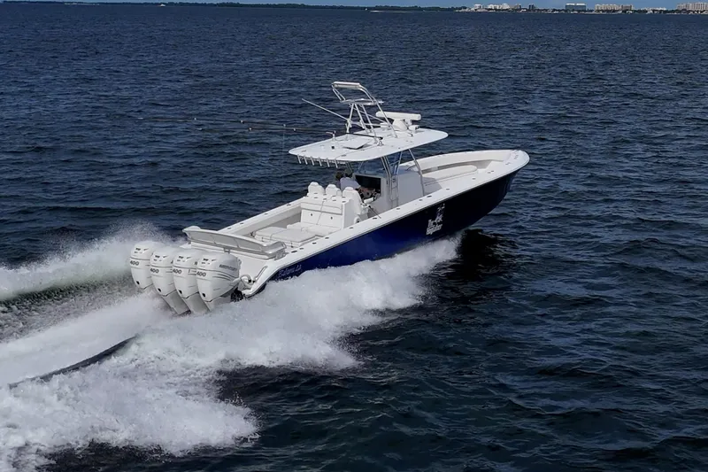 Slide: The Image of 2015 Bahama 41 boat cruising on open water with fishing rods. - 39