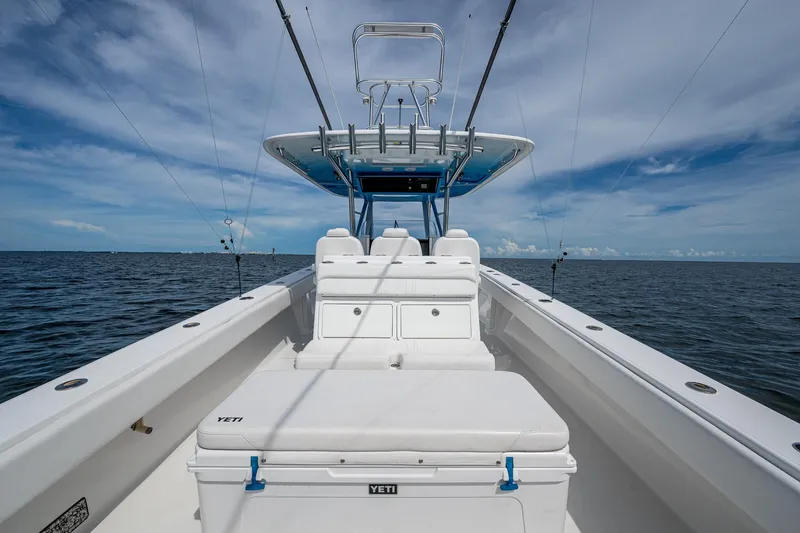 Slide: The Image of 2015 Bahama 41 boat on open water, featuring spacious deck and fishing rods. - 6