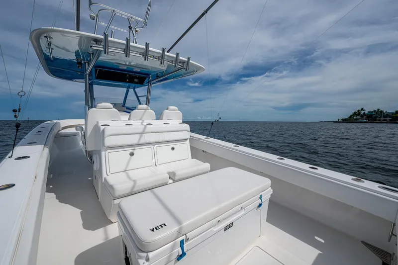 Slide: The Image of 2015 Bahama 41 boat interior with seating and ocean view under a cloudy sky. - 7