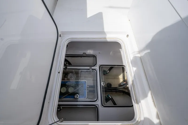 Slide: The Image of Open hatch of 2015 Bahama 41 boat showing internal compartments and wiring. - 8