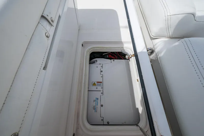 Slide: The Image of 2015 Bahama 41 boat storage compartment with electrical components visible. - 9