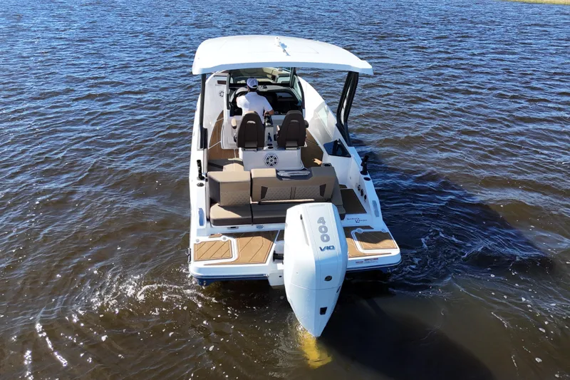 Slide: The Image of 2025 Monterey Elite 27 OB boat on water, rear view with outboard motor. - 16