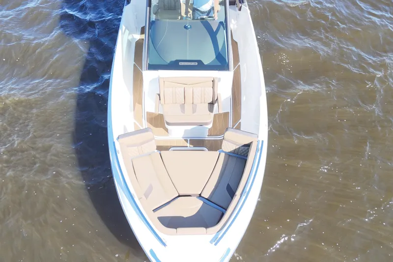 Slide: The Image of 2025 Monterey Elite 27 OB boat on water, featuring spacious seating and sleek design. - 18