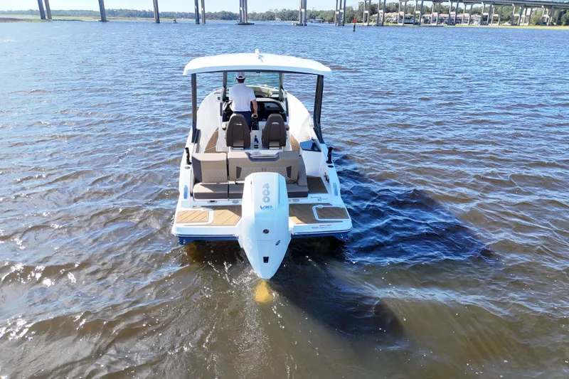 Slide: The Image of 2025 Monterey Elite 27 OB boat cruising on a sunny day, rear view. - 19