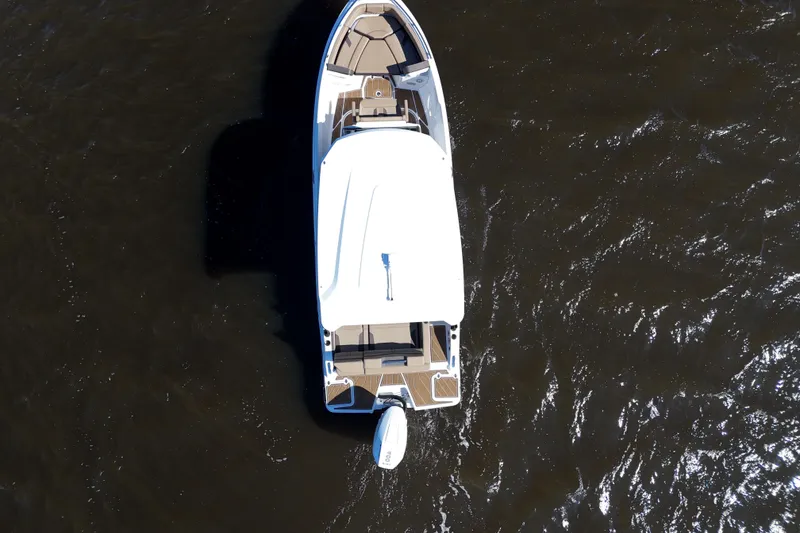 Slide: The Image of Aerial view of 2025 Monterey Elite 27 OB boat on dark water. - 22
