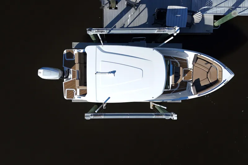 Slide: The Image of Aerial view of 2025 Monterey Elite 27 OB boat docked at a pier. - 33