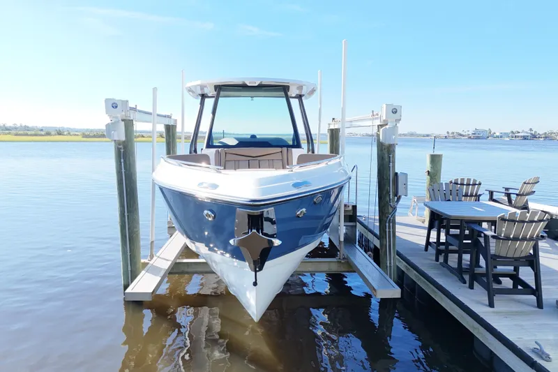 Slide: The Image of 2025 Monterey Elite 27 OB boat docked on a sunny day, with waterfront view. - 34