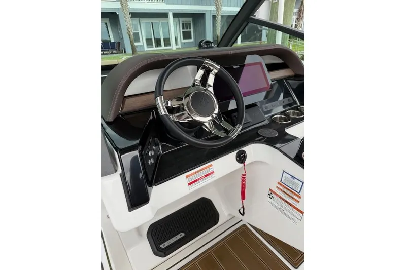 Slide: The Image of 2025 Monterey Elite 27 OB boat dashboard with steering wheel and modern controls. - 41