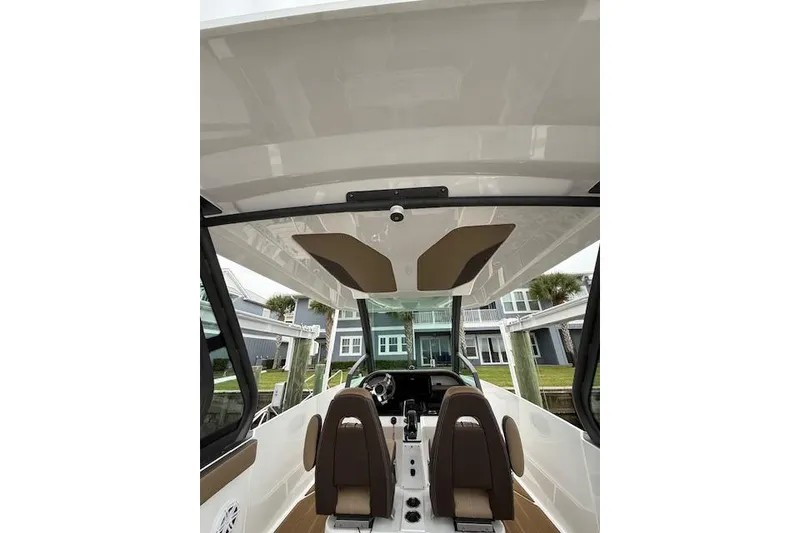 Slide: The Image of Interior view of 2025 Monterey Elite 27 OB boat, featuring modern seating and dashboard. - 50