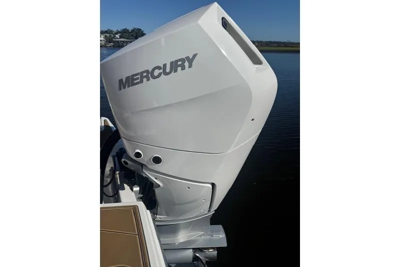 Slide: The Image of 2025 Monterey Elite 27 OB with Mercury outboard engine on water. - 59