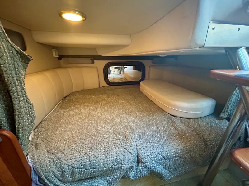 Slide: The Image of Interior cabin of 2002 Rinker 342 Fiesta Vee with cozy bed and ambient lighting. - 14
