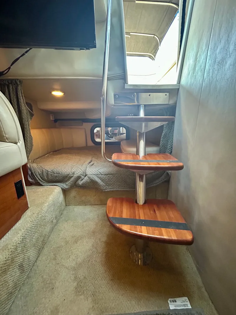 Slide: The Image of Interior of 2002 Rinker 342 Fiesta Vee with wooden steps and cozy sleeping area. - 15