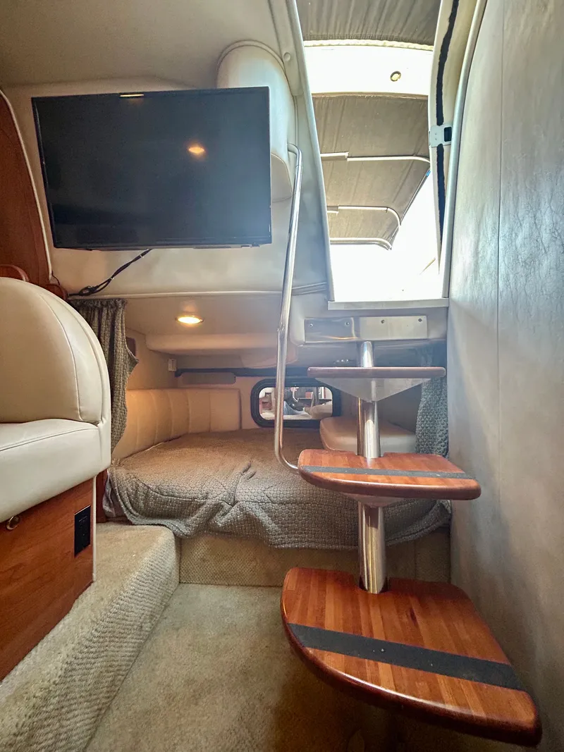 Slide: The Image of Interior of 2002 Rinker 342 Fiesta Vee boat with stairs, bed, and mounted TV. - 16