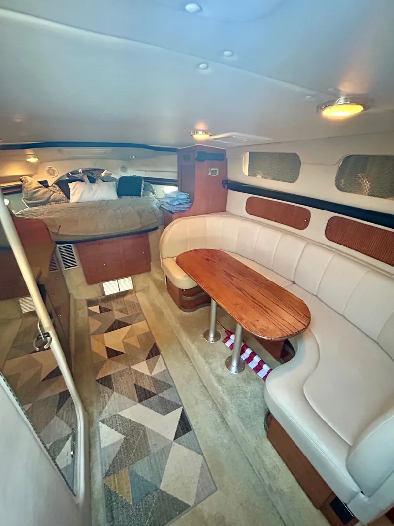 Slide: The Image of Interior of 2002 Rinker 342 Fiesta Vee yacht with cozy seating and bed area. - 17