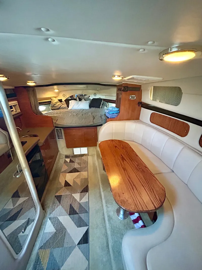 Slide: The Image of Interior of 2002 Rinker 342 Fiesta Vee boat with seating and sleeping area. - 18