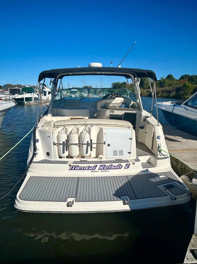 Slide: The Image of 2002 Rinker 342 Fiesta Vee boat docked at marina under clear blue sky. - 3
