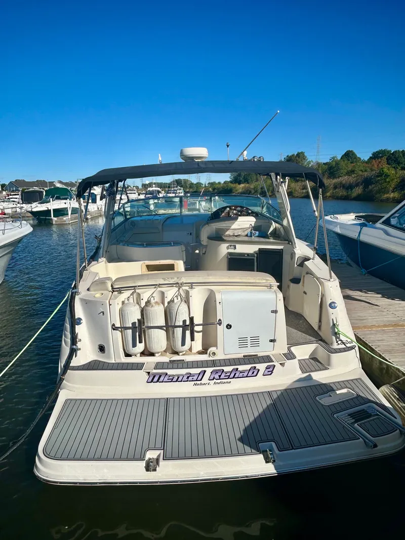 Slide: The Image of 2002 Rinker 342 Fiesta Vee boat docked at marina under clear blue sky. - 4