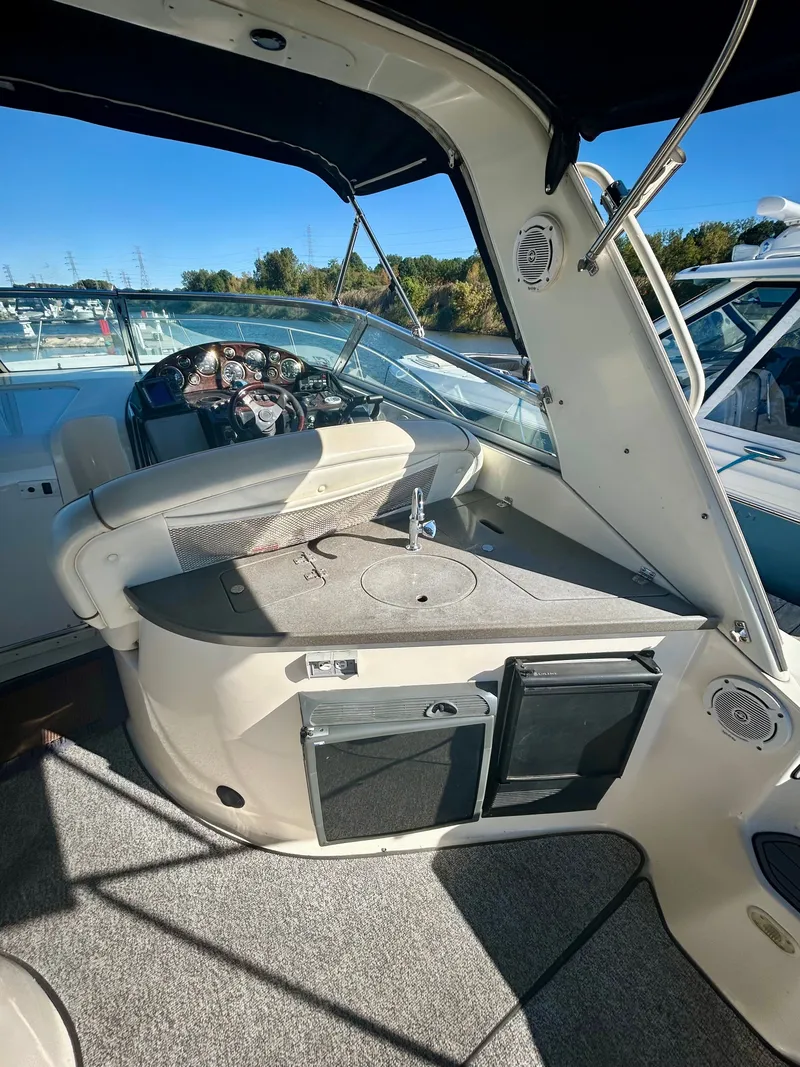 Slide: The Image of 2002 Rinker 342 Fiesta Vee boat interior with helm and seating area. - 5