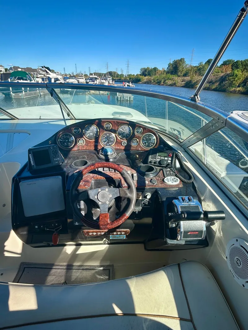 Slide: The Image of 2002 Rinker 342 Fiesta Vee boat cockpit with steering wheel and control panel. - 6