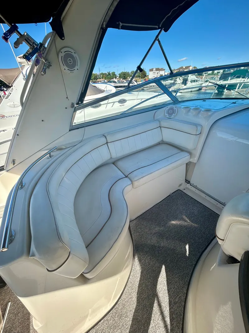 Slide: The Image of 2002 Rinker 342 Fiesta Vee boat interior with white seating and carpeted floor. - 7