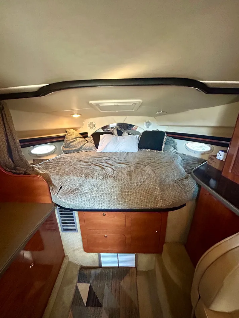 Slide: The Image of Cozy cabin interior of 2002 Rinker 342 Fiesta Vee with bed and wooden cabinetry. - 9