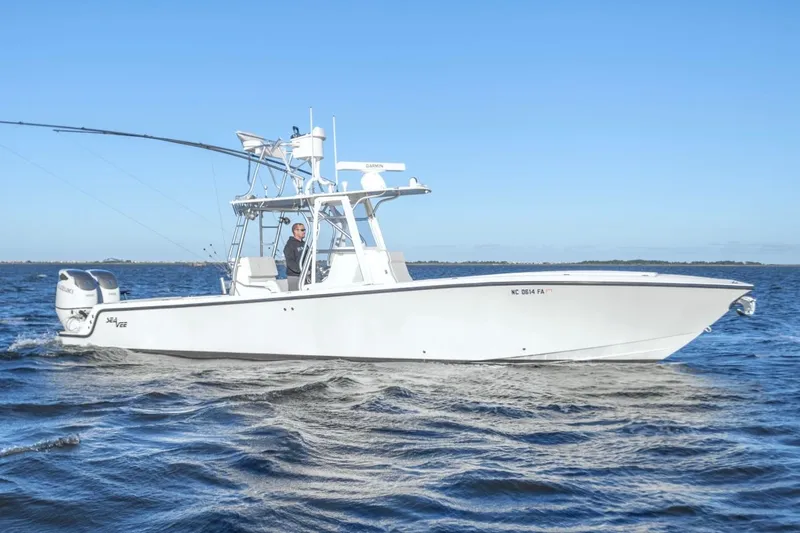 Slide: The Image of 2012 SeaVee 340B boat cruising on open water under clear blue sky. - 1