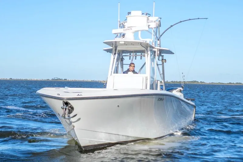 Slide: The Image of 2012 SeaVee 340B boat cruising on open water under clear blue sky. - 10