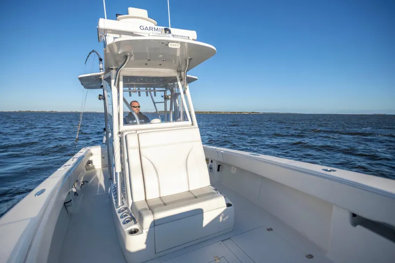 Slide: The Image of 2012 SeaVee 340B boat cruising on open water under clear blue sky. - 12