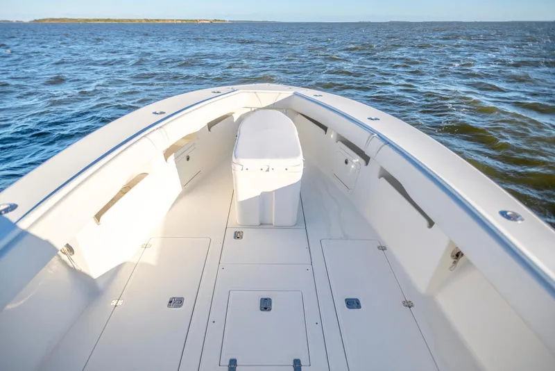 Slide: The Image of 2012 SeaVee 340B boat deck with ocean view, showcasing spacious design and storage compartments. - 13