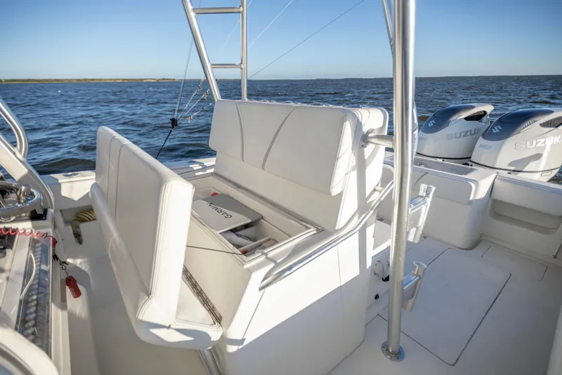 Slide: The Image of 2012 SeaVee 340B boat interior with Suzuki engines, white seating, and Garmin equipment. - 17