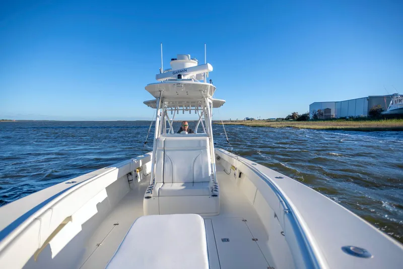 Slide: The Image of 2012 SeaVee 340B boat cruising on open water under clear blue sky. - 18