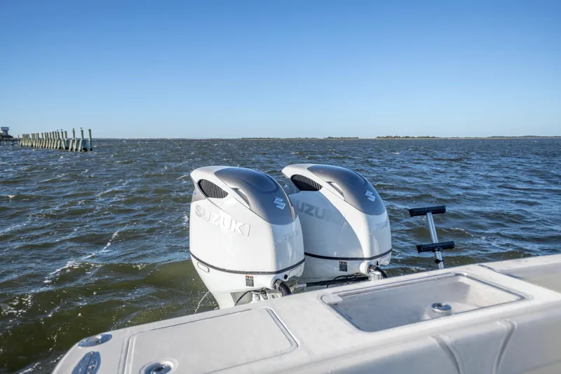 Slide: The Image of Twin Suzuki outboard engines on a 2012 SeaVee 340B boat in open water. - 19