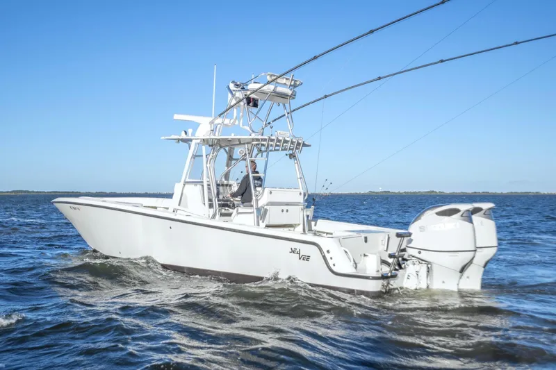 Slide: The Image of 2012 SeaVee 340B boat cruising on open water under clear blue skies. - 2