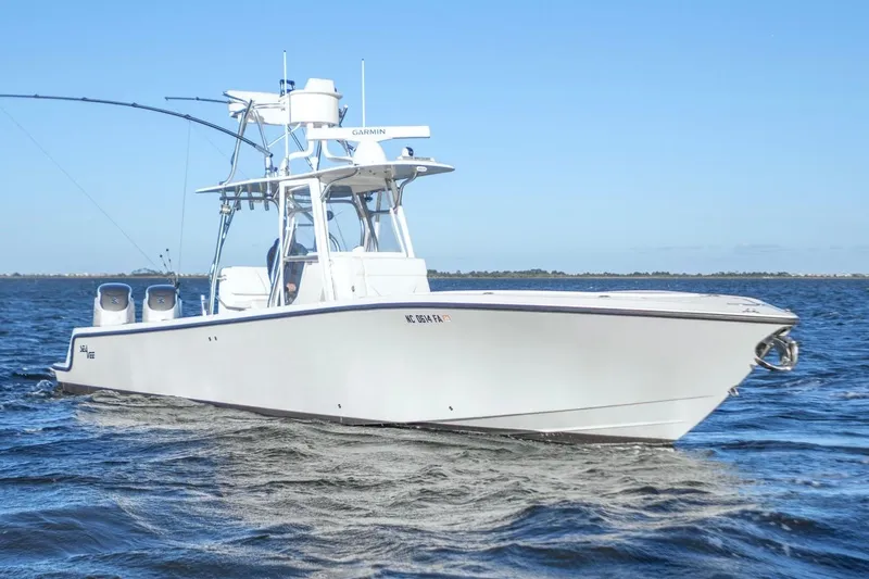 Slide: The Image of 2012 SeaVee 340B boat cruising on open water under clear blue skies. - 4