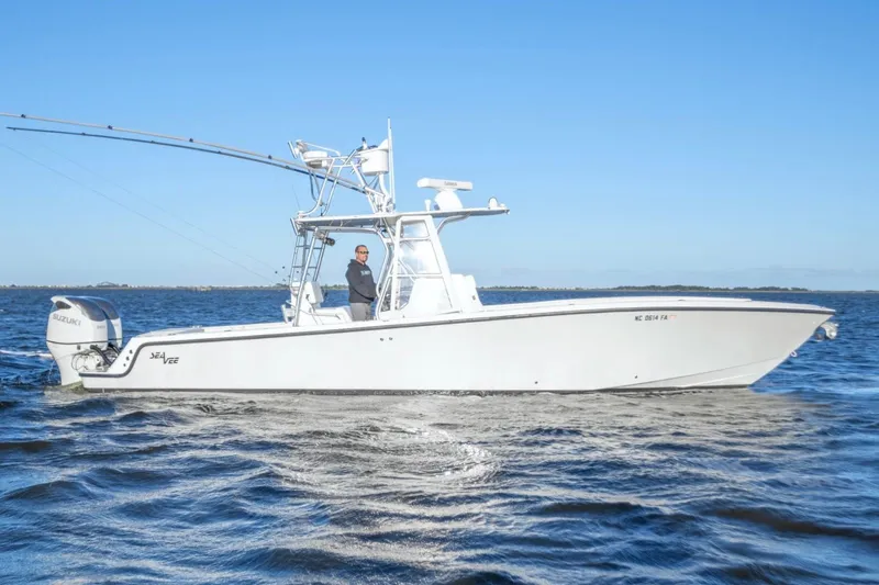 Slide: The Image of 2012 SeaVee 340B boat cruising on open water under clear blue sky. - 5