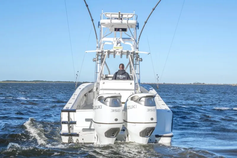 Slide: The Image of 2012 SeaVee 340B boat with dual Suzuki 350 engines cruising on open water. - 6