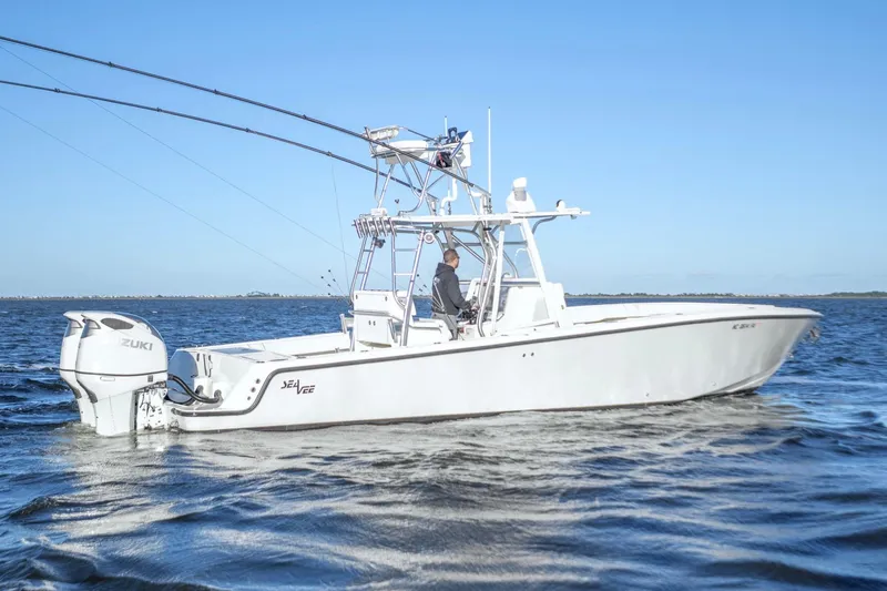 Slide: The Image of 2012 SeaVee 340B boat on water, featuring Suzuki outboard engines, clear blue sky. - 7