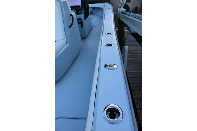 Slide: The Image of 2019 Conch 33 boat interior with rod holders along the side. - 10
