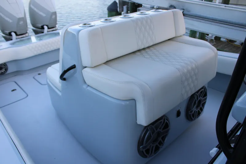 Slide: The Image of Luxury seating on 2019 Conch 33 boat with dual speakers and cup holders. - 11