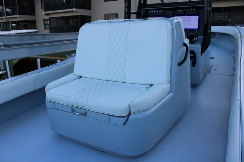 Slide: The Image of 2019 Conch 33 boat interior with cushioned seating and control panel. - 13
