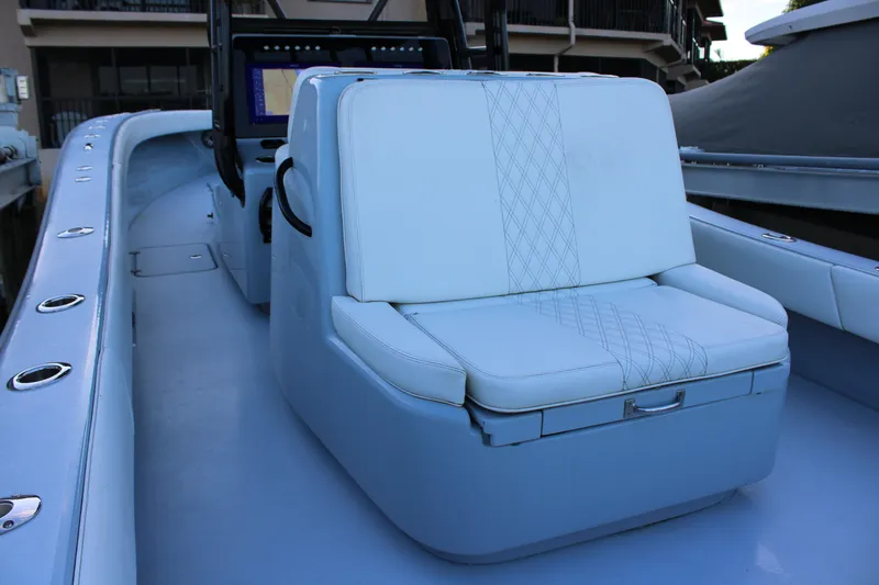 Slide: The Image of 2019 Conch 33 boat interior with cushioned seating and control panel. - 14