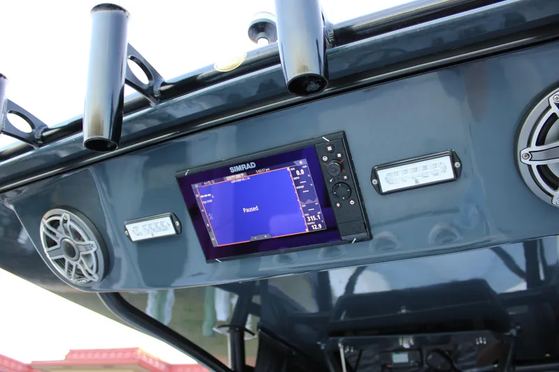 Slide: The Image of 2019 Conch 33 boat dashboard with Simrad display and speakers. - 17