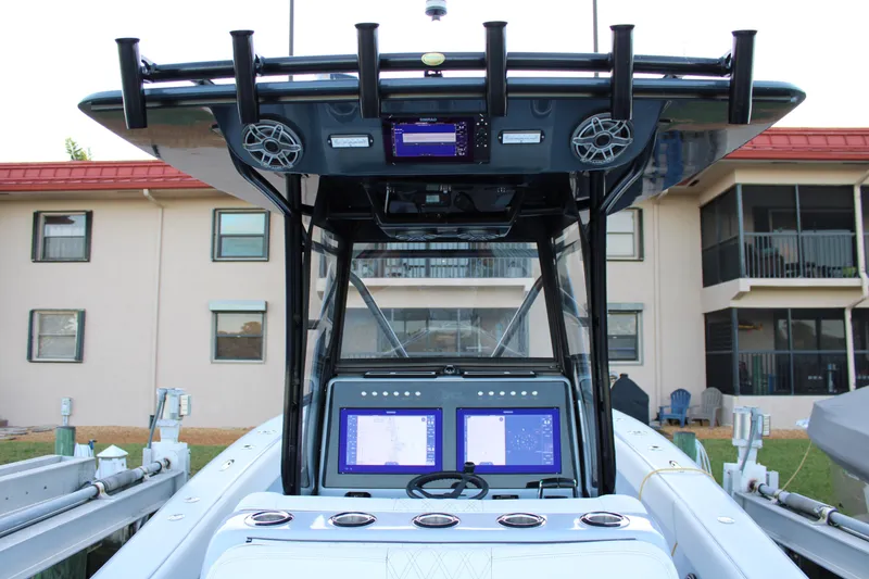 Slide: The Image of 2019 Conch 33 boat dashboard with dual navigation screens and speakers. - 18