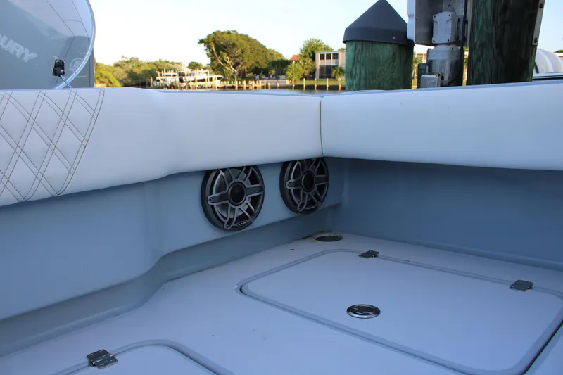 Slide: The Image of Interior of 2019 Conch 33 boat with speakers and cushioned seating. - 23