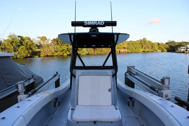 Slide: The Image of 2019 Conch 33 boat with Simrad equipment docked by a scenic river. - 27