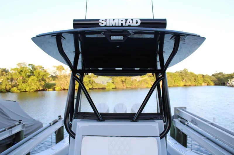 Slide: The Image of 2019 Conch 33 boat with Simrad electronics, docked by a scenic waterfront. - 28