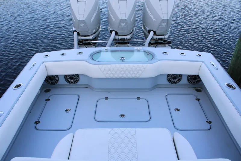 Slide: The Image of 2019 Conch 33 boat interior with triple Mercury engines, spacious seating, and storage compartments. - 3