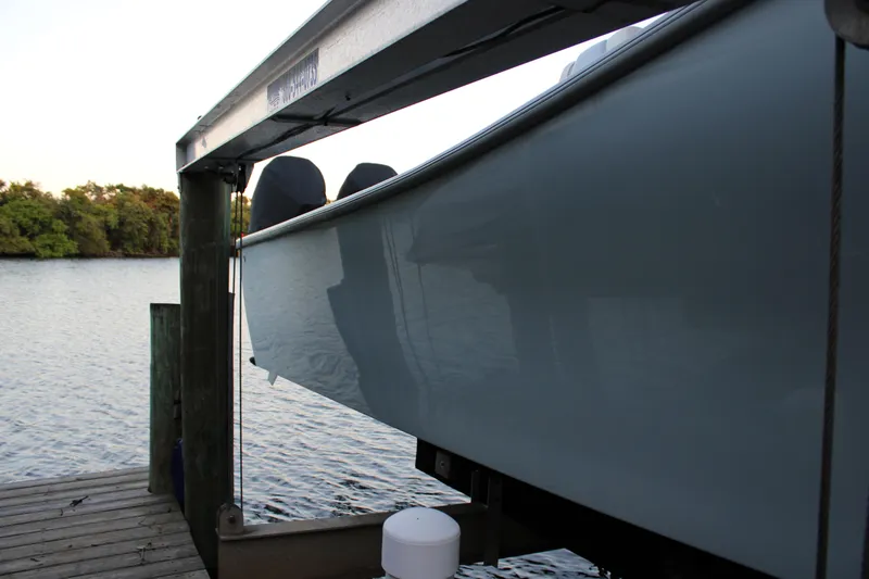 Slide: The Image of 2019 Conch 33 boat on lift by waterfront dock. - 33